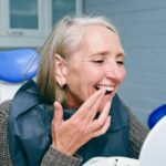 woman smiling at dentist after full mouth restoration in Amarillo